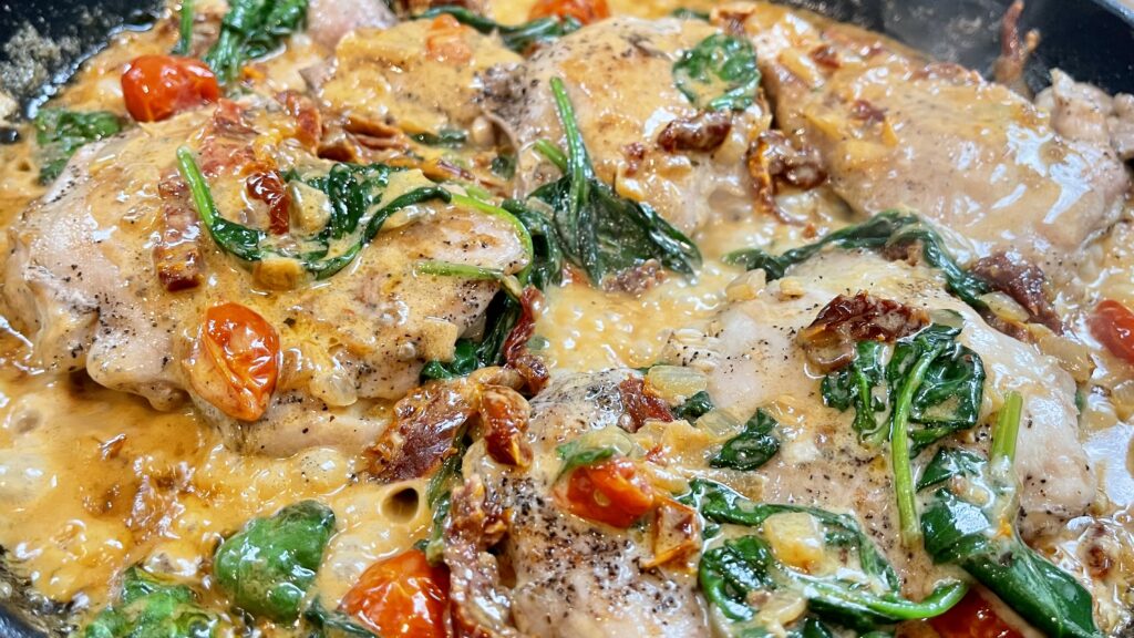 close-up image of one skillet tuscan chicken dish